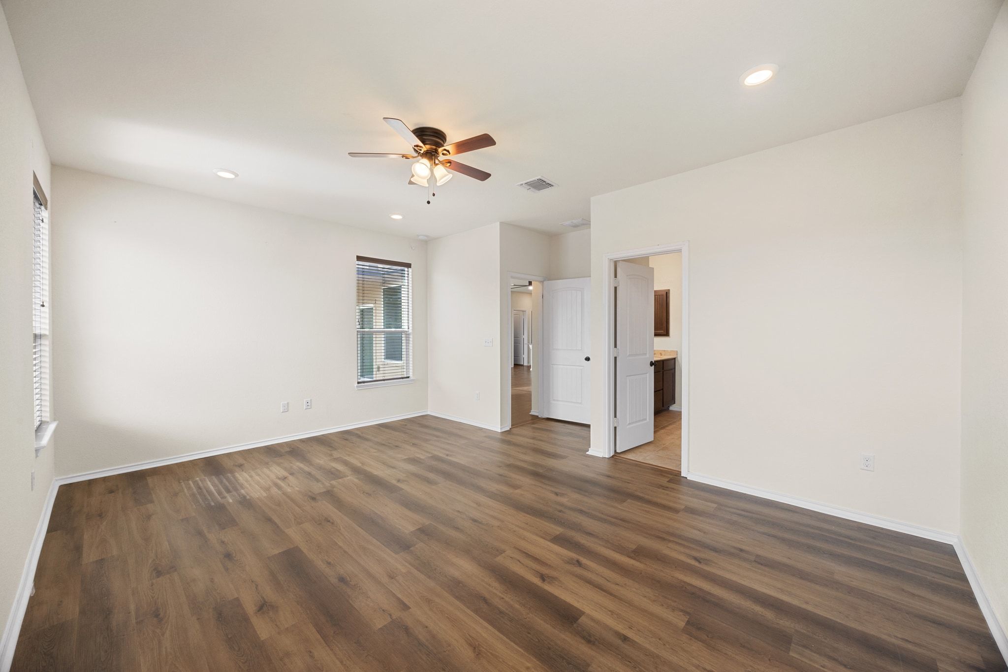 136 Vickers Street Georgetown, TX 78628 - Photo 17 of 33 a view of empty room with wooden floor and fan