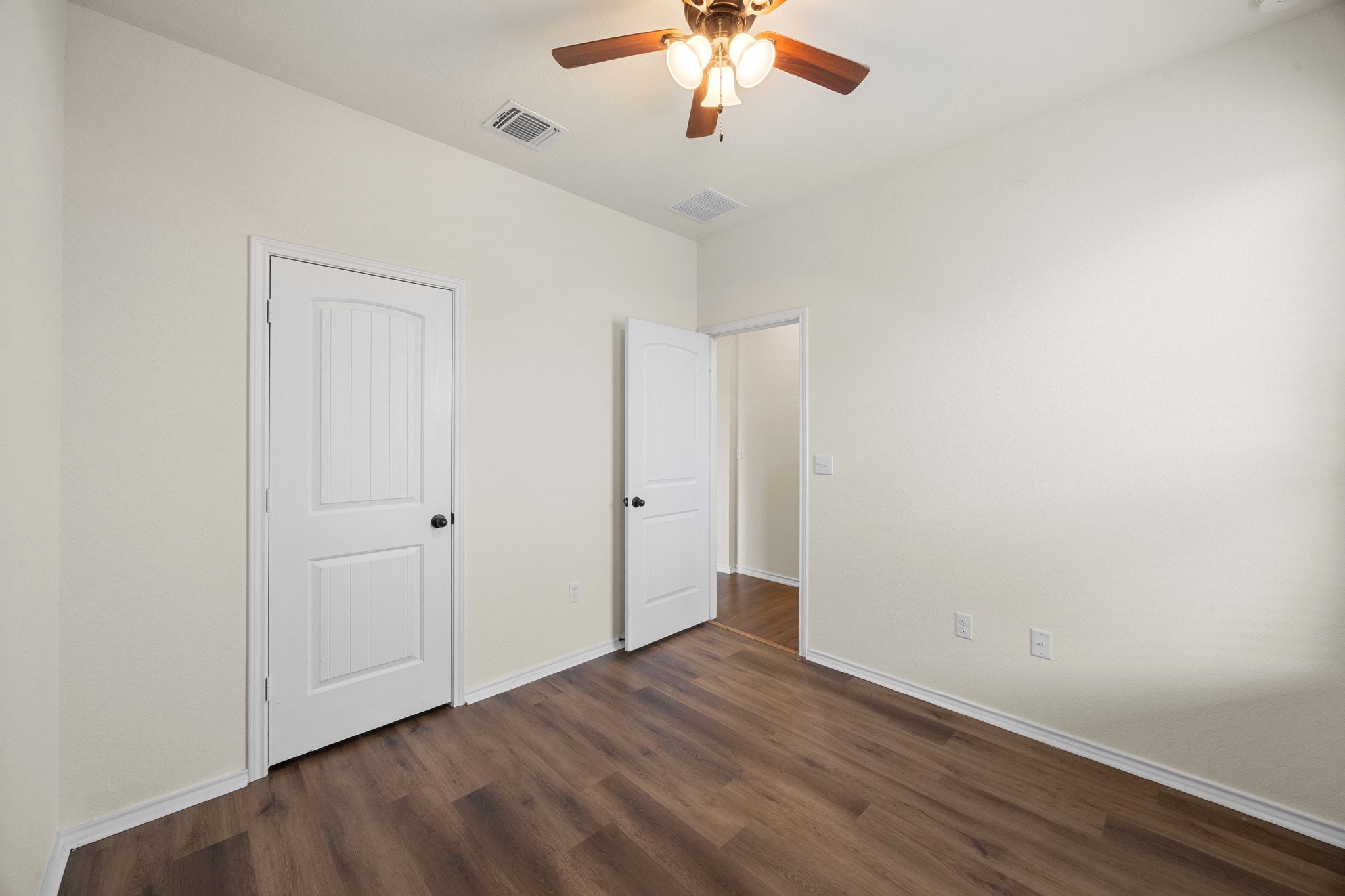 136 Vickers Street Georgetown, TX 78628 - Photo 24 of 33 an empty room with a chandelier fan and wooden floor