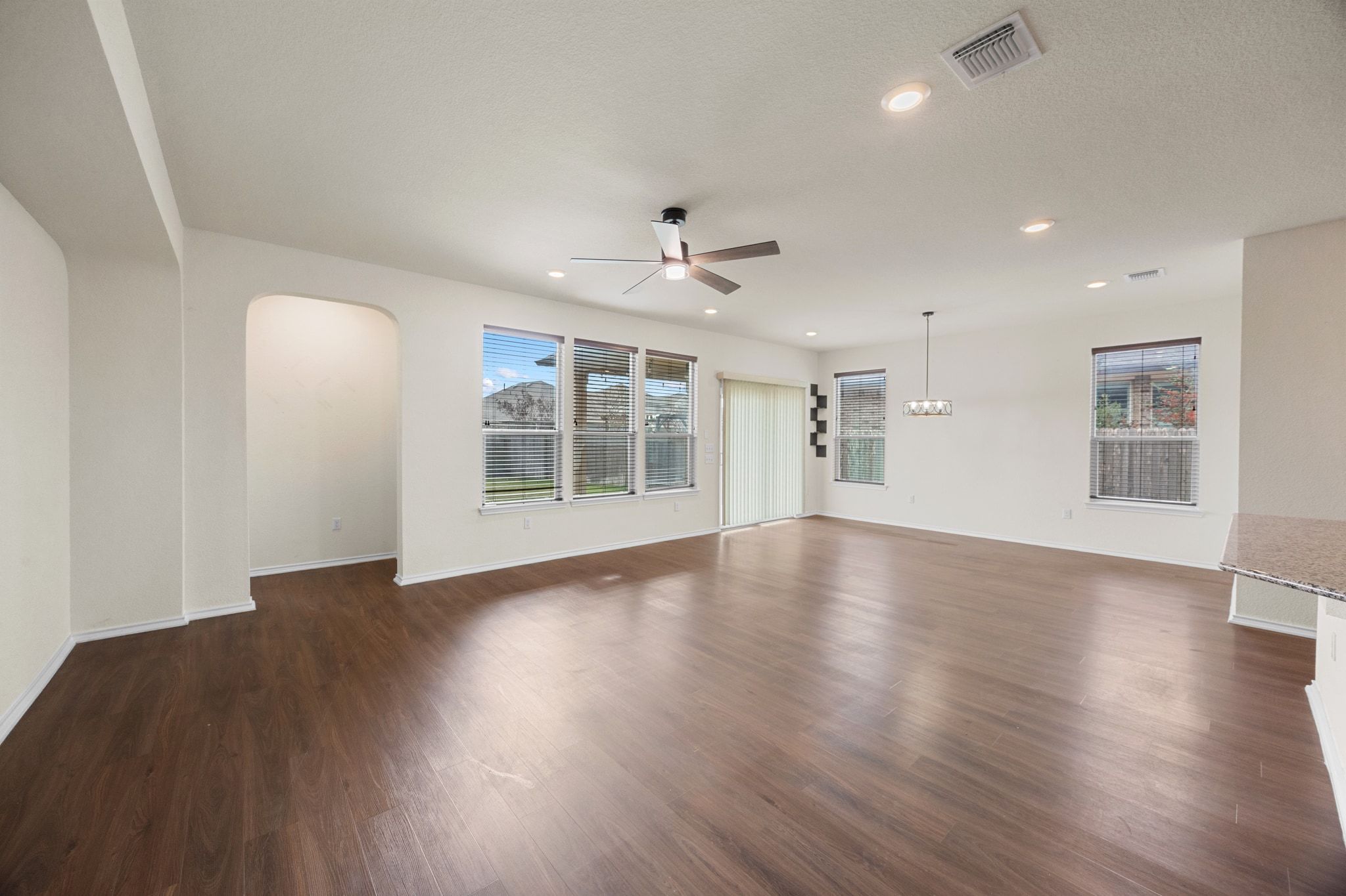 136 Vickers Street Georgetown, TX 78628 - Photo 7 of 33 a view of an empty room with wooden floor and a window