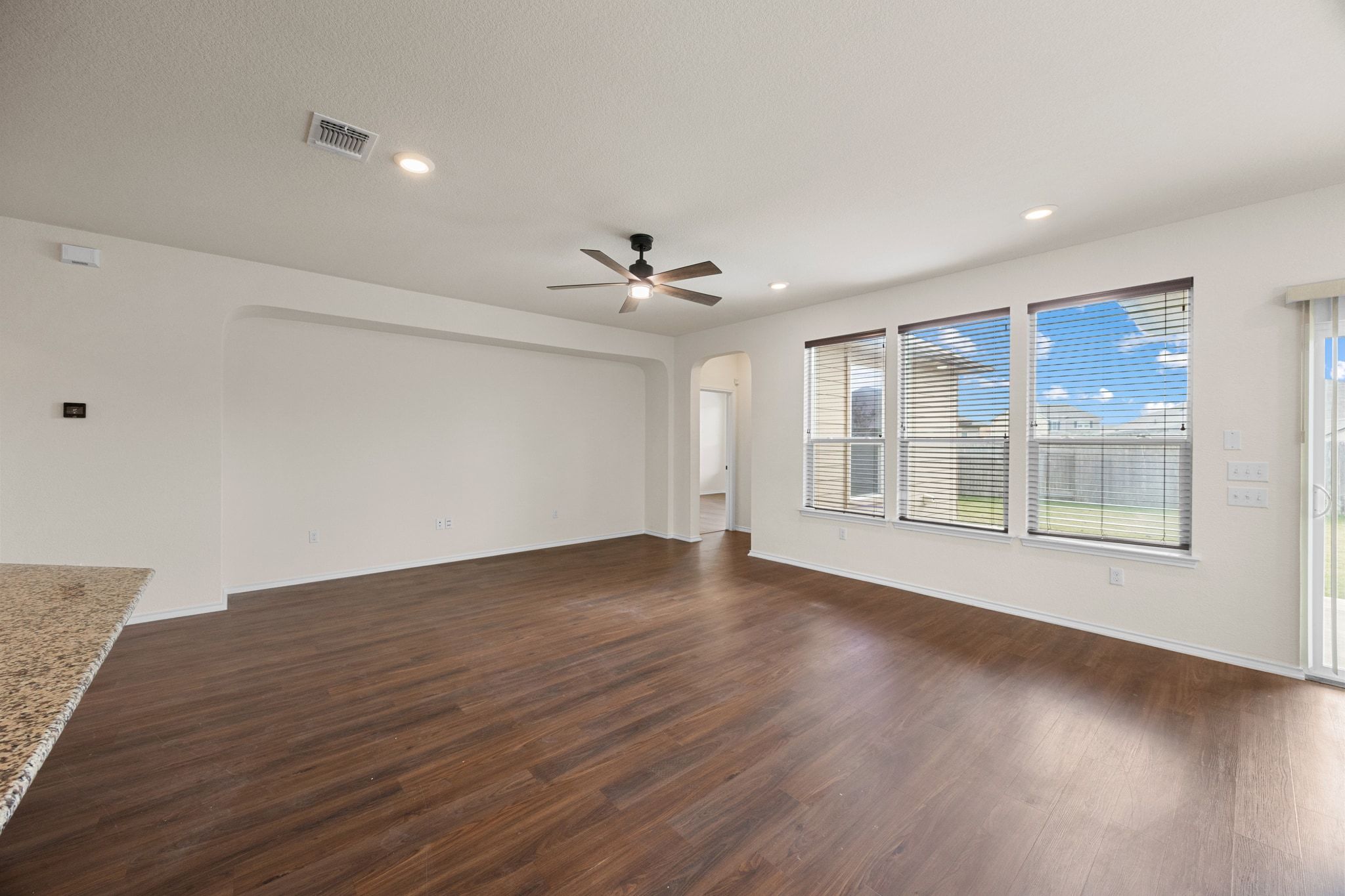 136 Vickers Street Georgetown, TX 78628 - Photo 9 of 33 a view of an empty room with a window and wooden floor