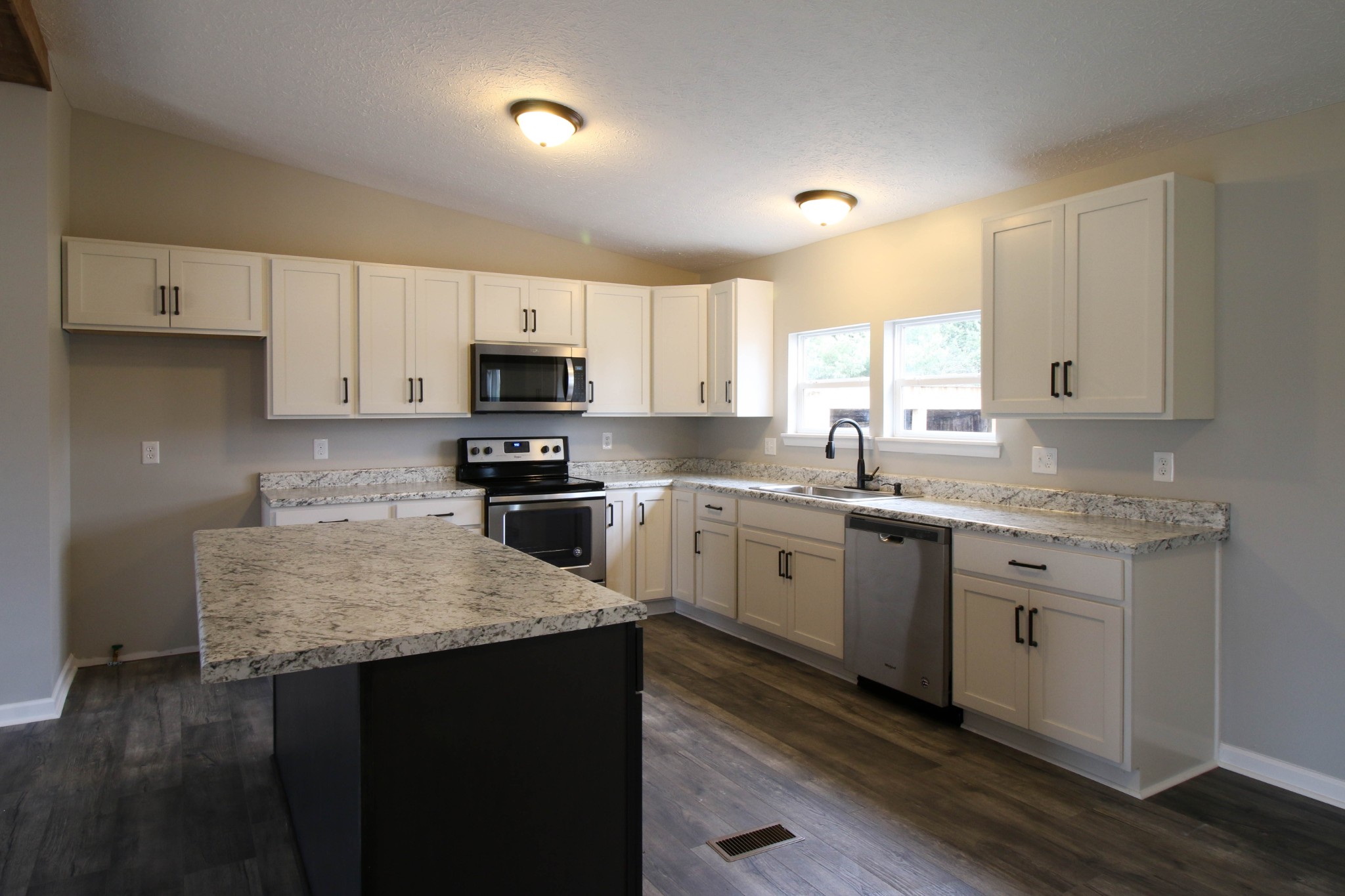 4413 Woodrow Wilson Road Springfield, TN 37172 - Photo 8 of 19 a kitchen with granite countertop white cabinets sink and stainless steel appliances
