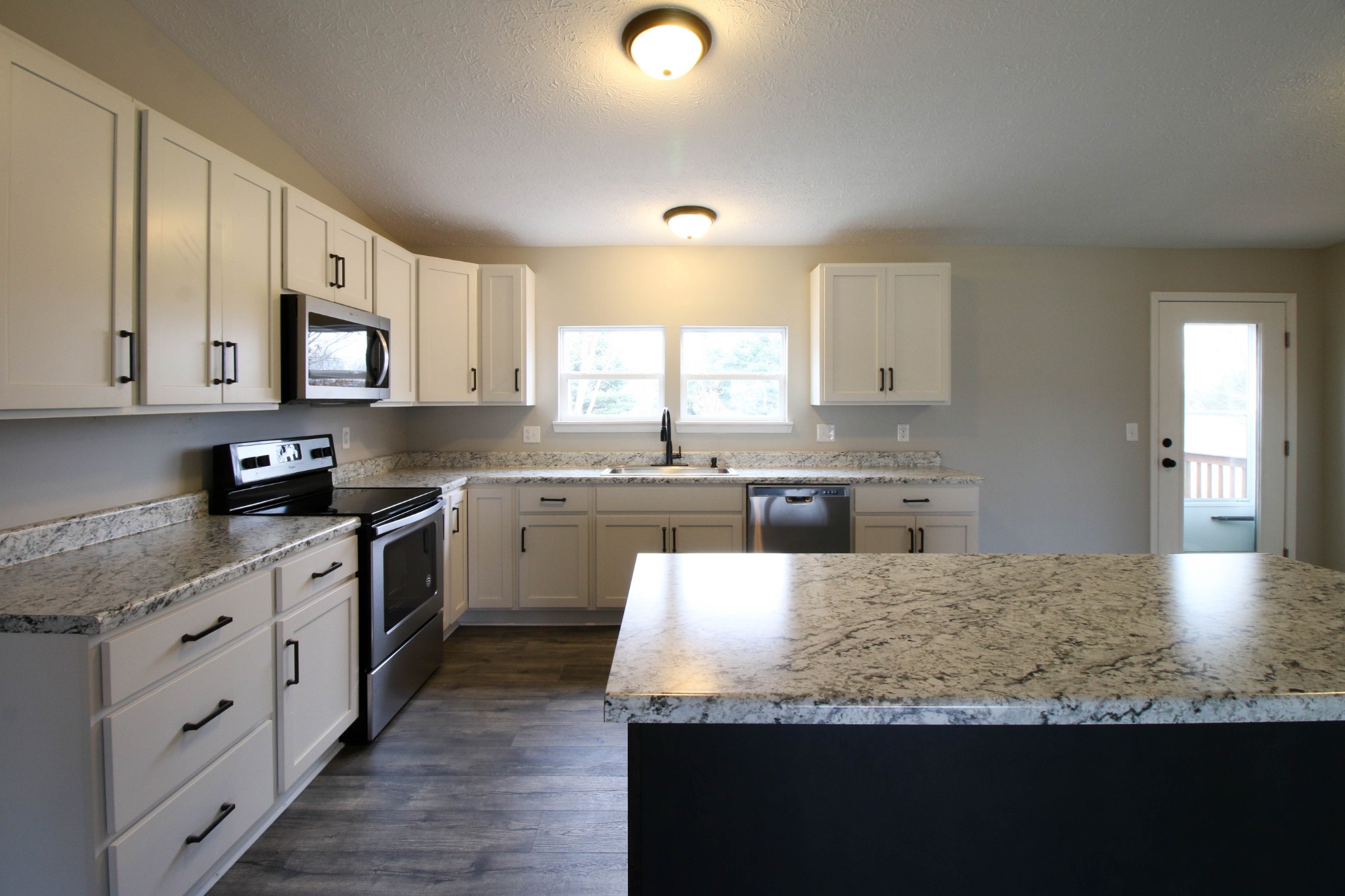 4413 Woodrow Wilson Road Springfield, TN 37172 - Photo 9 of 19 a kitchen with granite countertop a sink stainless steel appliances and cabinets