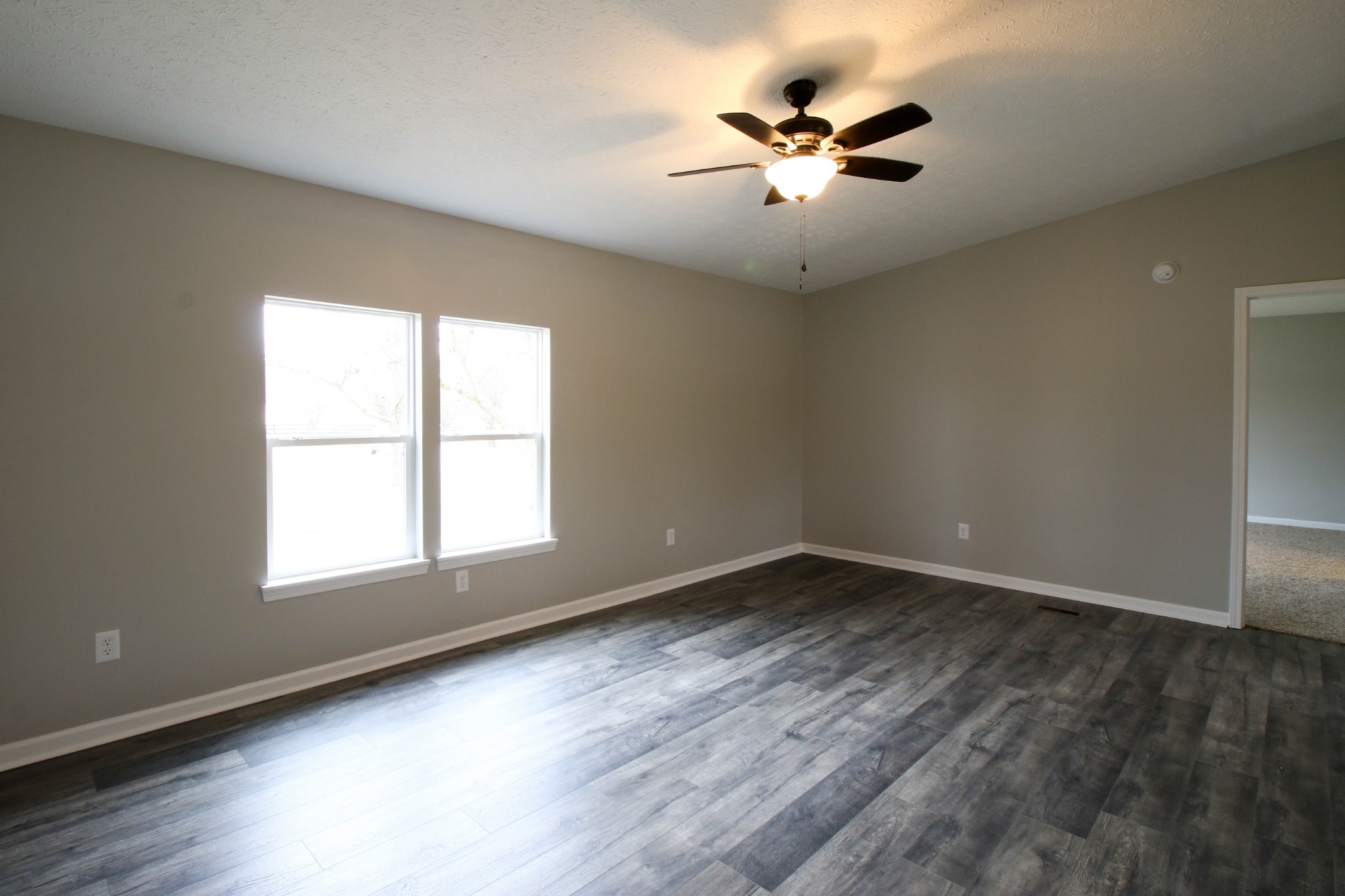 4413 Woodrow Wilson Road Springfield, TN 37172 - Photo 10 of 19 an empty room with wooden floor fan and windows