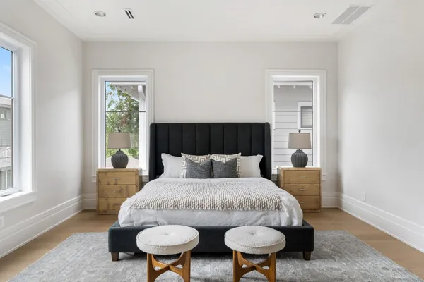 a bed sitting in a bedroom next to a window