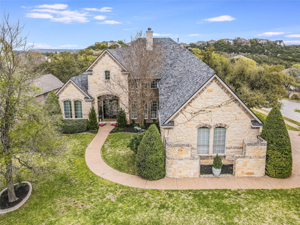 This elegant 2-story Limestone residence with charming brick accents seamlessly blends the tranquility of hill country and lake living with all the modern conveniences of city life.