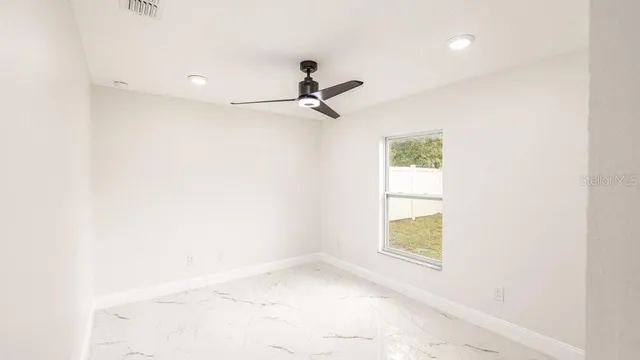 a bathroom with a granite countertop sink a toilet and shower