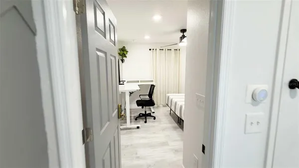 a view of a hallway with couch and a window