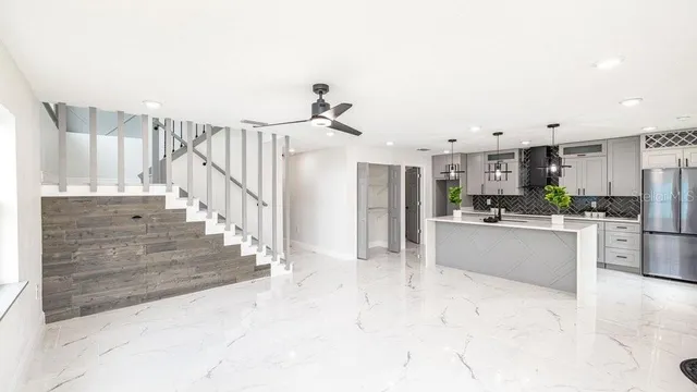 a view of kitchen with furniture and refrigerator