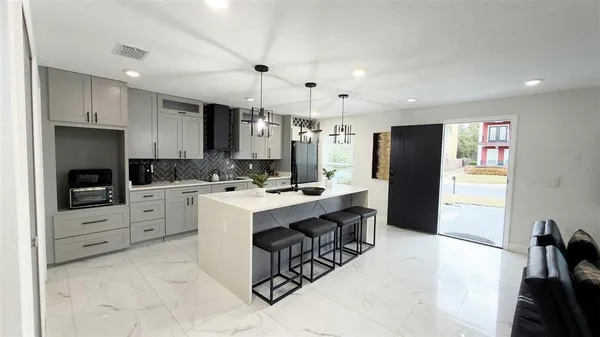 a kitchen with white cabinets and stainless steel appliances