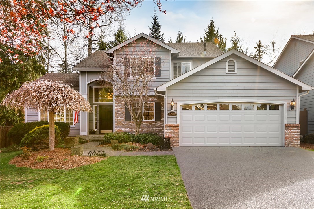 a front view of a house with a yard and garage
