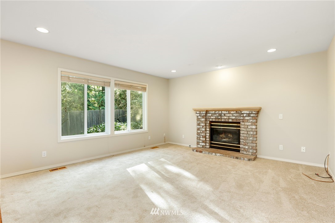 19907 29th Drive Southeast Bothell, WA 98012 - Photo 11 of 25 en empty room with a fireplace and a window