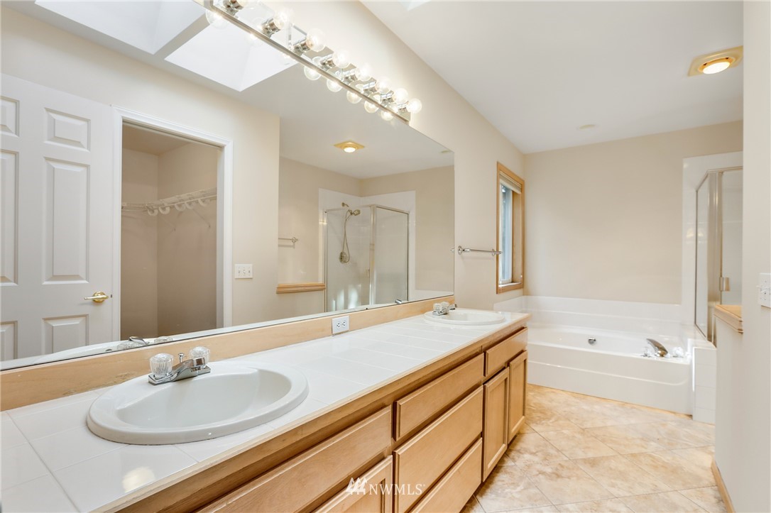 19907 29th Drive Southeast Bothell, WA 98012 - Photo 19 of 25 a bath room with a sink and a mirror