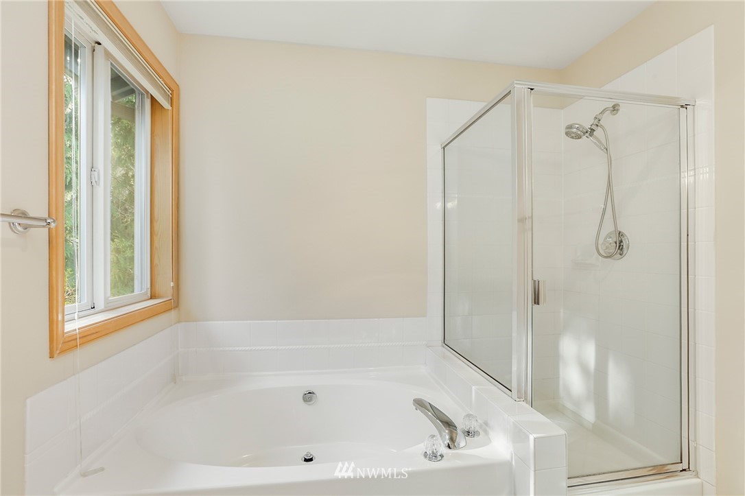 19907 29th Drive Southeast Bothell, WA 98012 - Photo 20 of 25 a bathroom with a bathtub and a shower