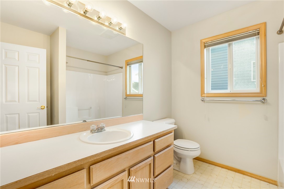 19907 29th Drive Southeast Bothell, WA 98012 - Photo 21 of 25 a bathroom with a sink a toilet and a window