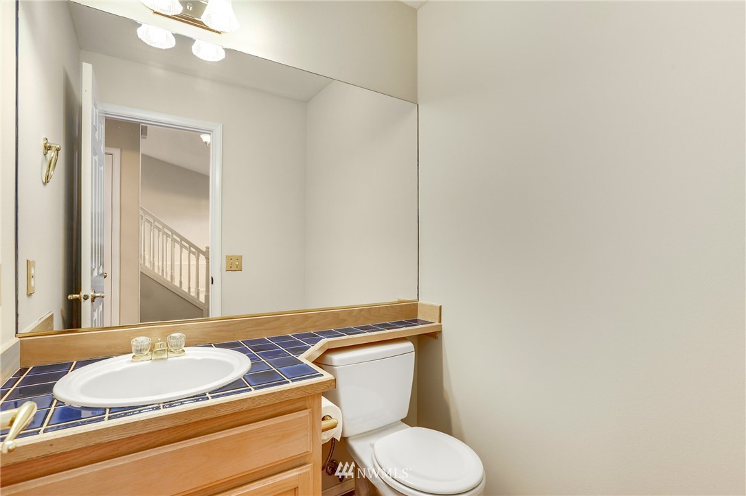 19907 29th Drive Southeast Bothell, WA 98012 - Photo 22 of 25 a bathroom with a granite countertop toilet sink and mirror