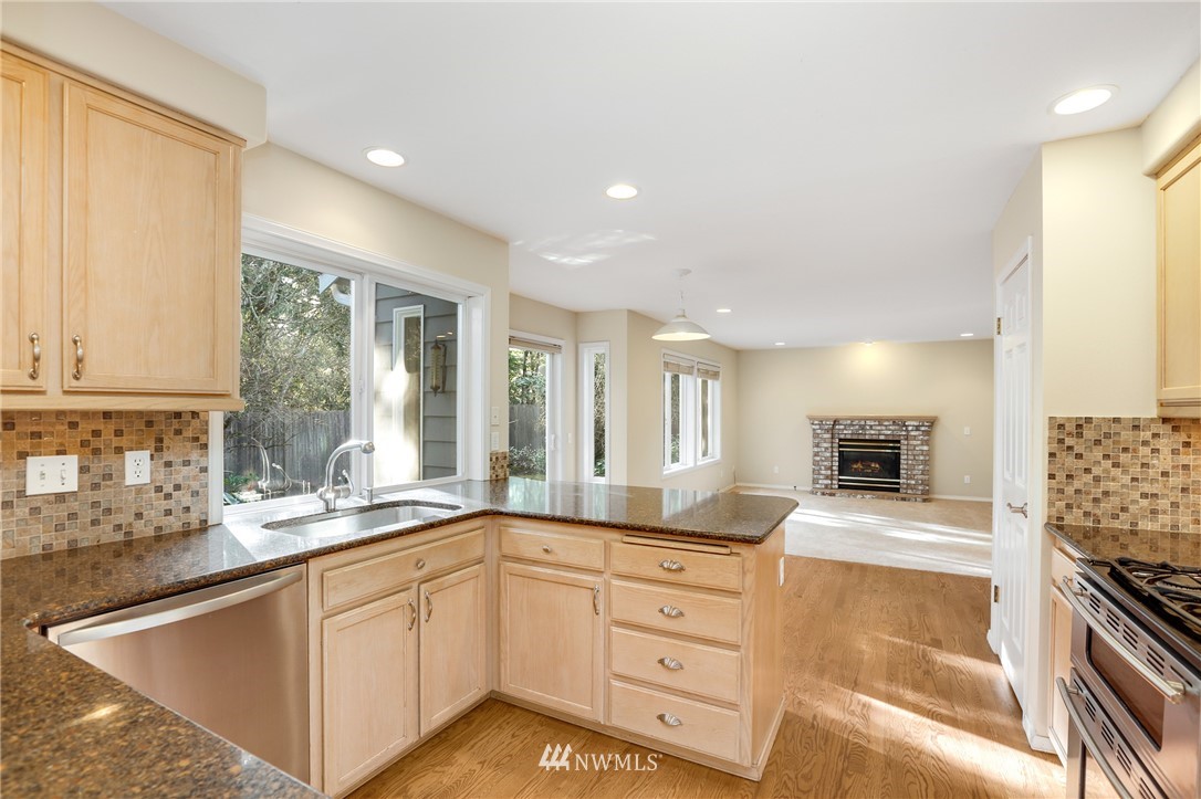 19907 29th Drive Southeast Bothell, WA 98012 - Photo 4 of 25 a kitchen with a sink stove and microwave