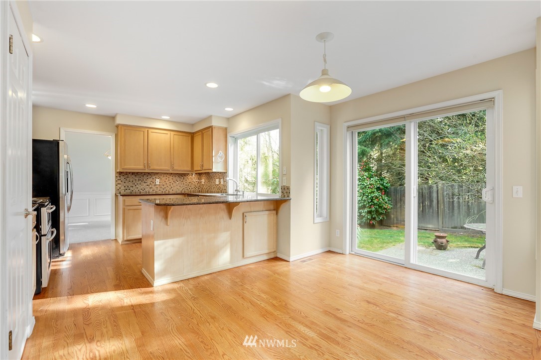 19907 29th Drive Southeast Bothell, WA 98012 - Photo 6 of 25 a view of a kitchen with kitchen island a large window cabinets a sink and stainless steel appliances