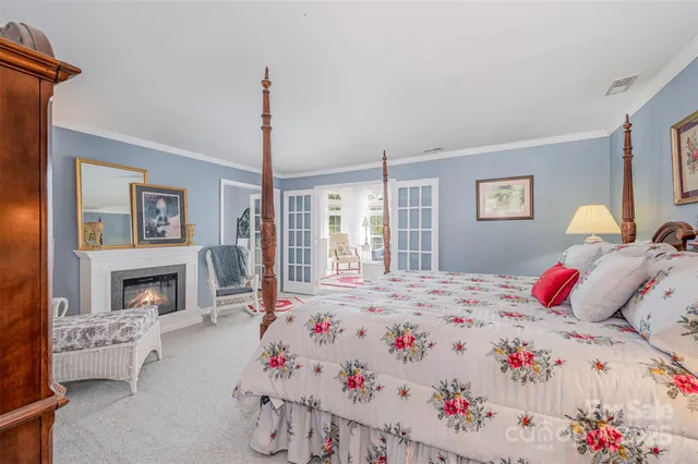 a bed room with a bed next to a fireplace