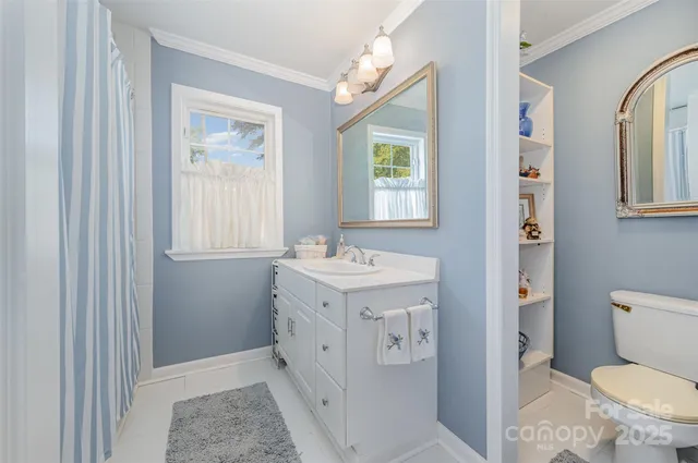 a spacious bathroom with a sink a toilet and a mirror