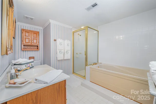a bathroom with a granite countertop sink a toilet and shower
