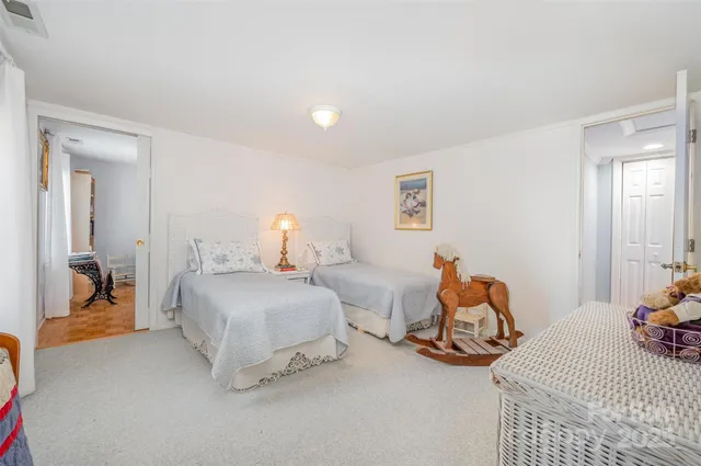 a bedroom with two beds and a lamp