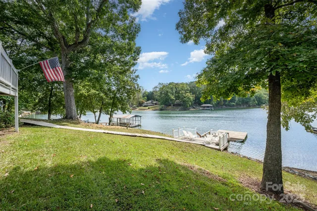 a view of a house with pool and a yard