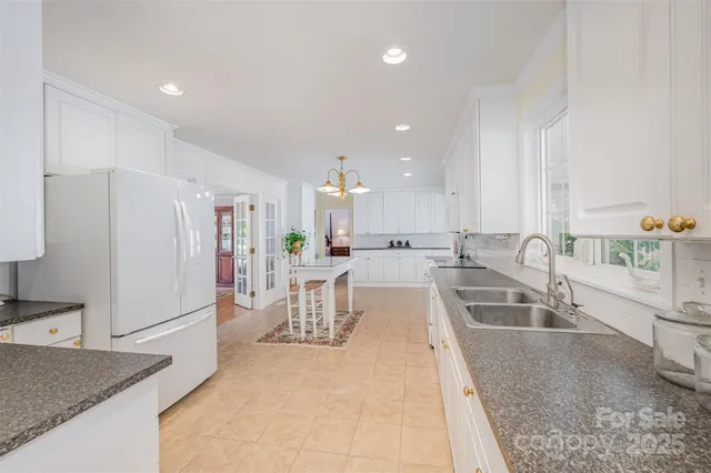 a large kitchen with lots of counter space and windows
