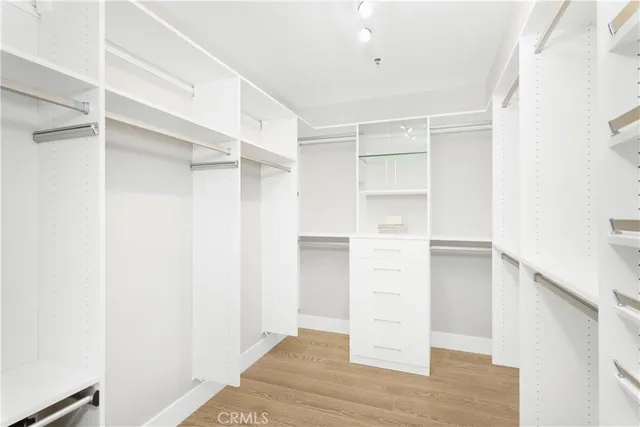 a bedroom with a bed and cabinets