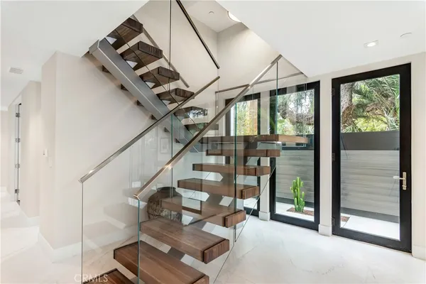 a view of entryway and hall with wooden floor