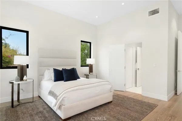 a bedroom with a large bed and a large window