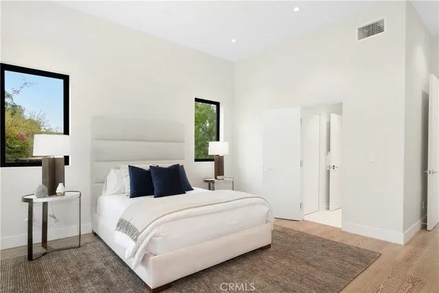 a bedroom with a large bed and a large window