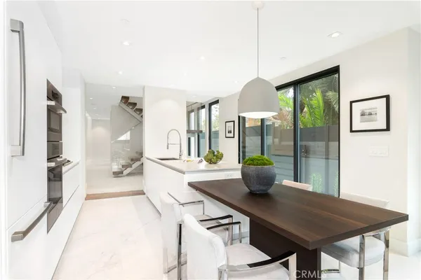 a kitchen with a table and chairs