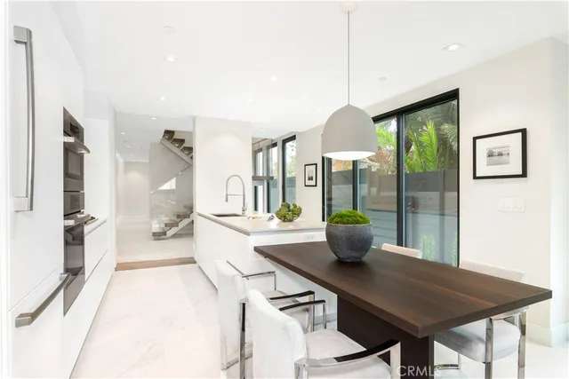 a kitchen with a table and chairs