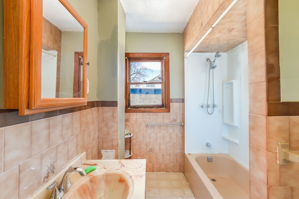 58 Downing Street Fall River, MA 02723 - Photo 13 of 41 a bathroom with a tub shower and sink
