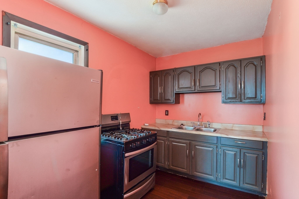 58 Downing Street Fall River, MA 02723 - Photo 18 of 41 a kitchen with stainless steel appliances granite countertop a sink stove and refrigerator