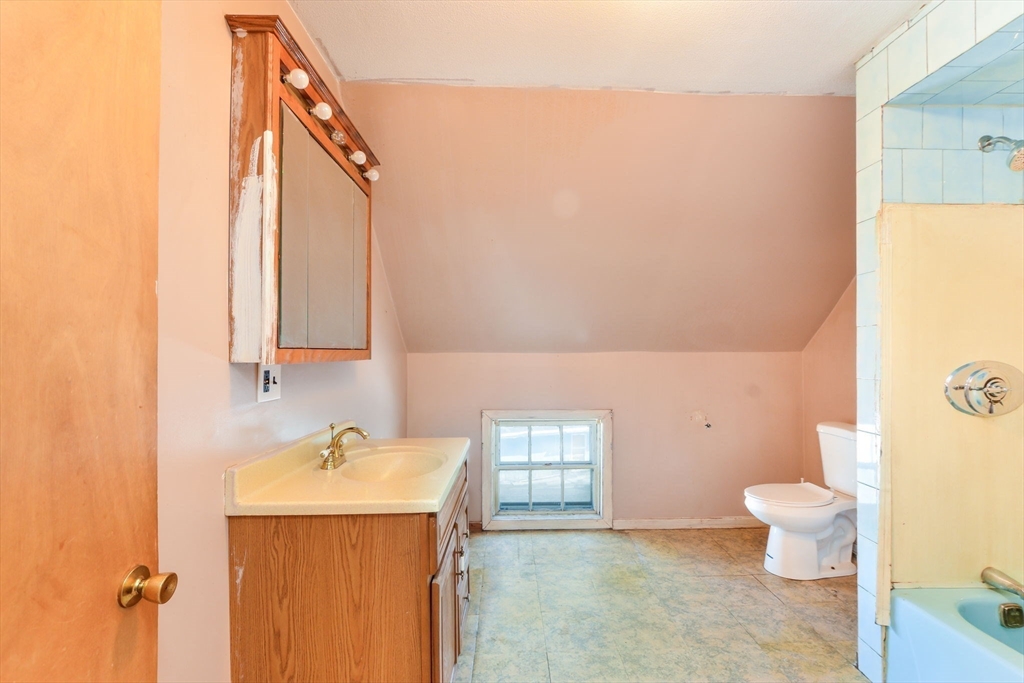 58 Downing Street Fall River, MA 02723 - Photo 20 of 41 a bathroom with a sink a toilet and shower curtain