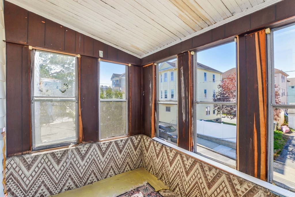 58 Downing Street Fall River, MA 02723 - Photo 24 of 41 a view of a hallway with a bed and glass door