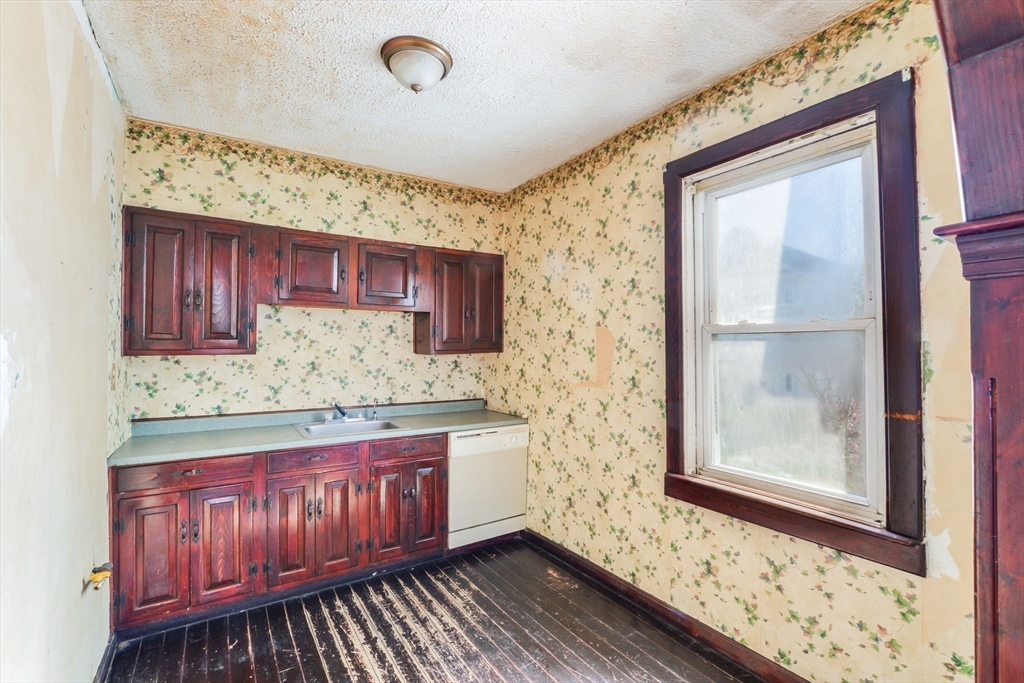 58 Downing Street Fall River, MA 02723 - Photo 28 of 41 a bathroom with a sink a mirror and a window