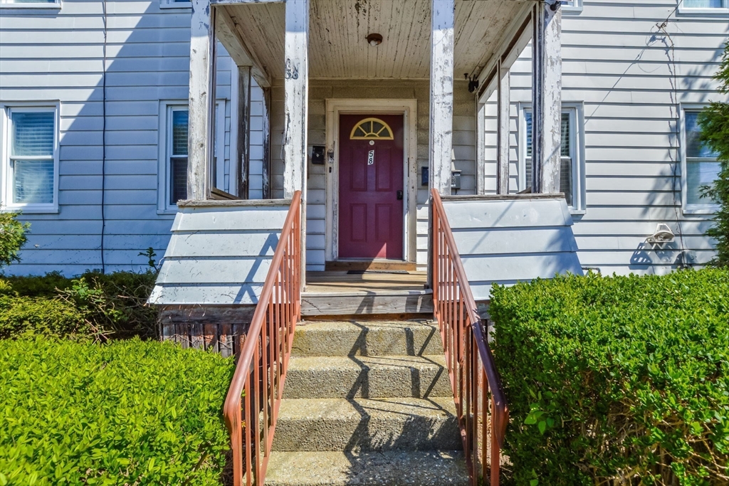 58 Downing Street Fall River, MA 02723 - Photo 3 of 41 a view of a brick house with a large windows and flower plants