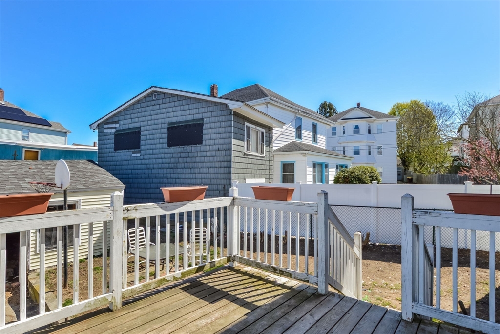58 Downing Street Fall River, MA 02723 - Photo 36 of 41 a view of a brick house with wooden fence
