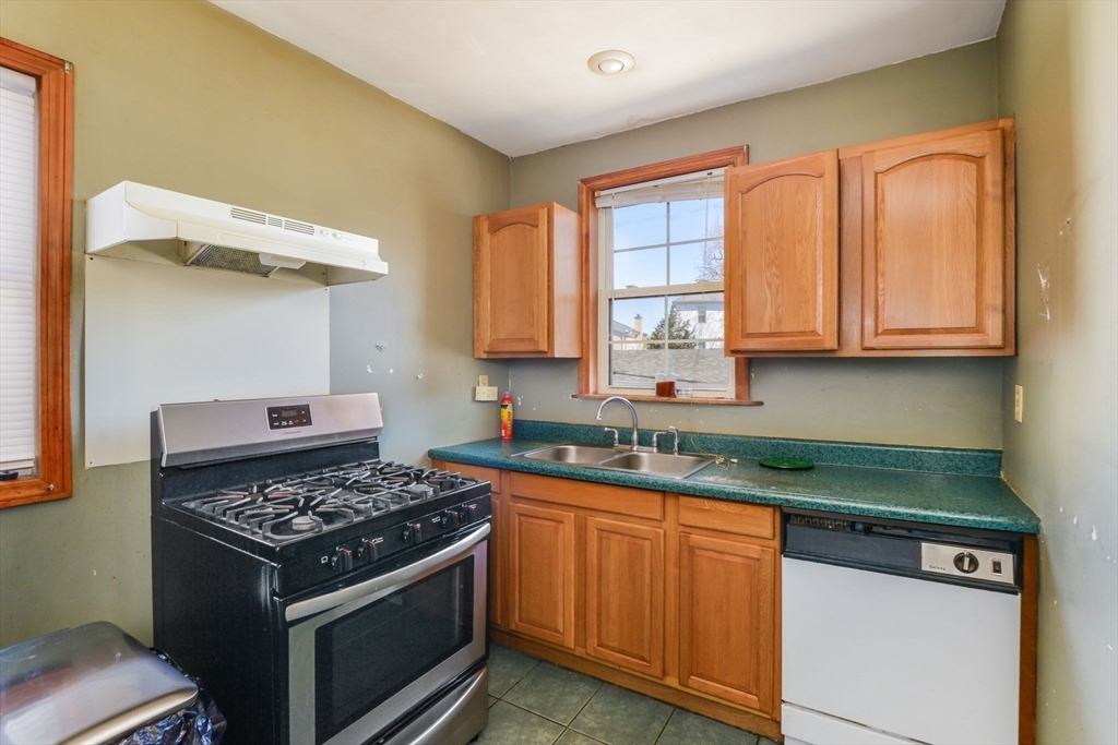 58 Downing Street Fall River, MA 02723 - Photo 8 of 41 a kitchen with stainless steel appliances granite countertop a stove and a sink