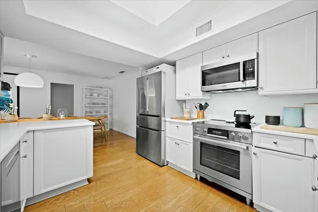 a view of a swimming pool with a patio and a yard