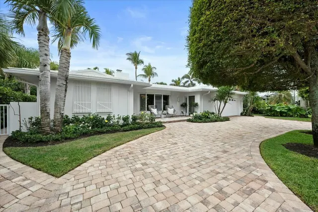a view of a house with sitting area and garden