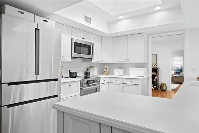 a view of living room with kitchen island furniture and floor to ceiling window