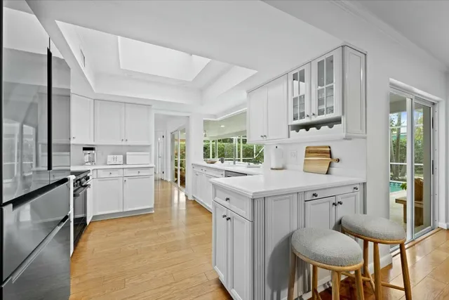 a view of deck with table and chairs potted plants with wooden floor