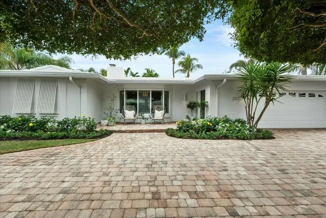 a front view of a house with a yard and a garage