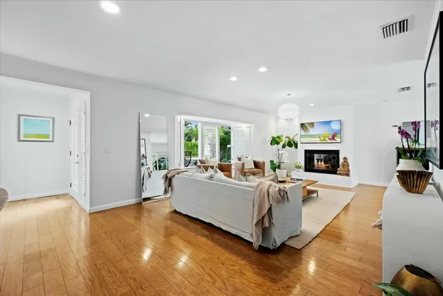 a living room with fireplace furniture and a wooden floor