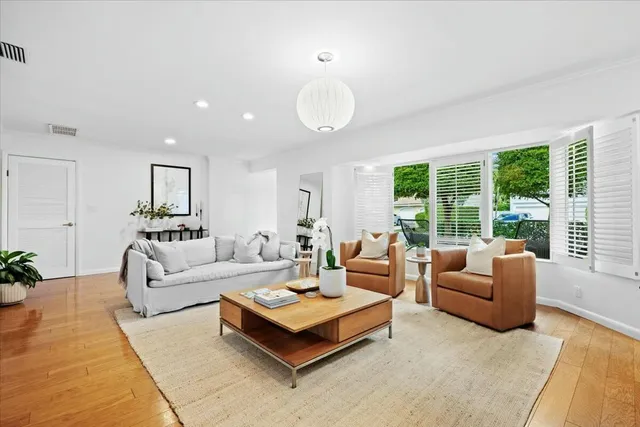 a kitchen with cabinets stainless steel appliances and wooden floor