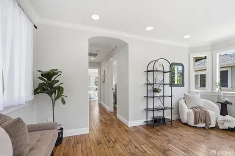 a living room with furniture and a potted plant