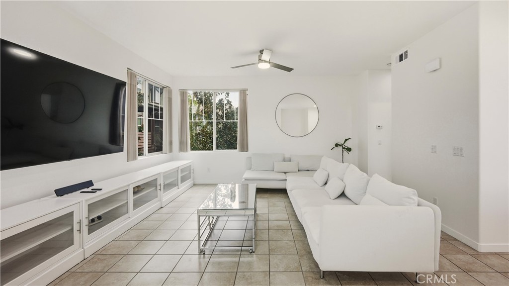 713 South Azusa Avenue, Unit A Azusa, CA 91702 - Photo 12 of 31 a living room with furniture a flat screen tv and a floor to ceiling window